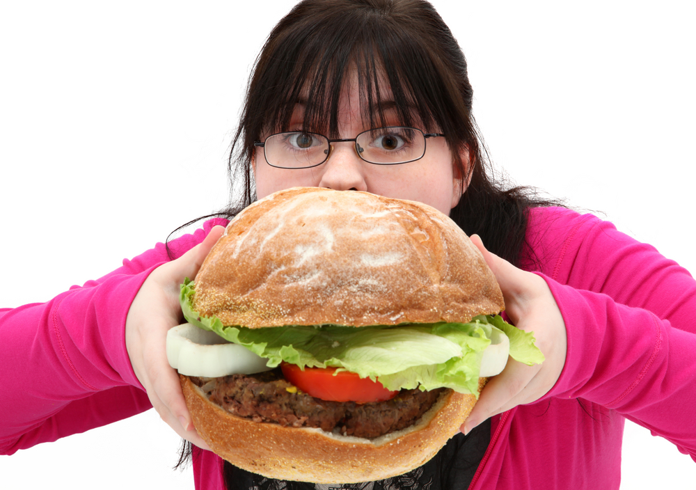 Girl eats huge hamburger
