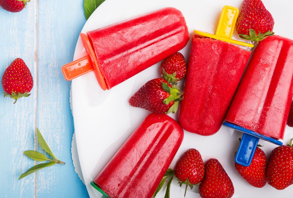 strawberry popsicles with colorful sticks ice cream