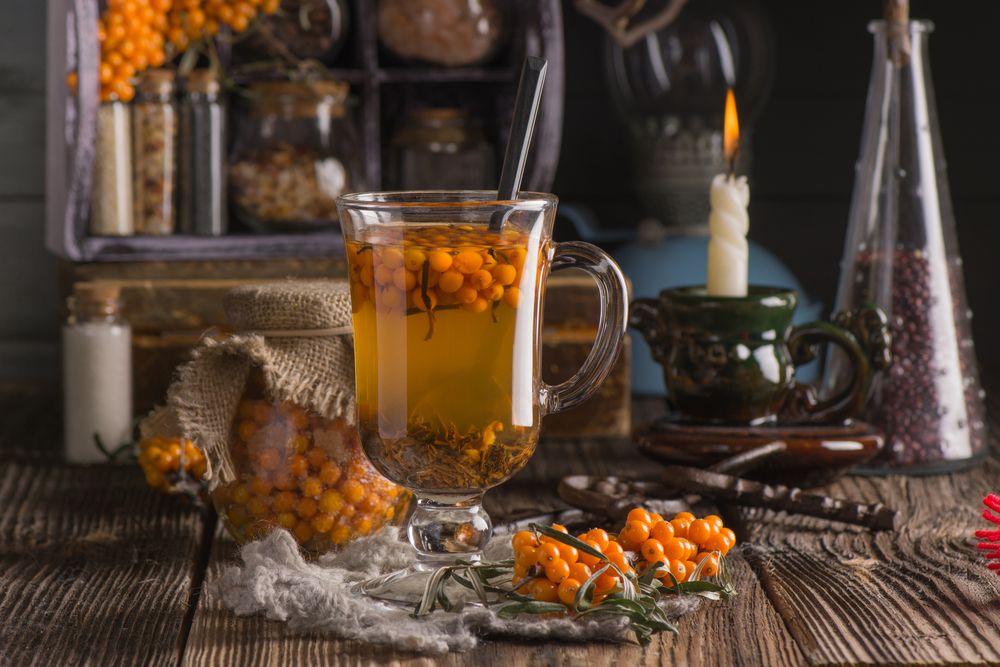 autumn-still-life-with-hot-high-vitamin-beverage-with-seabuckthorn-in-the-tall-glass