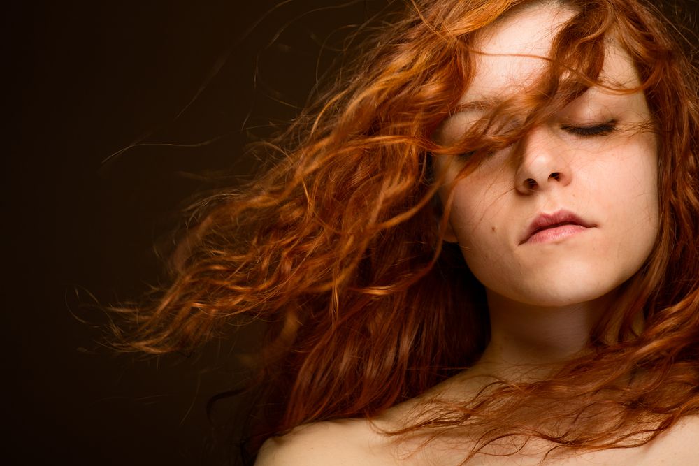 sexy-redhead-woman-with-blurred-hair
